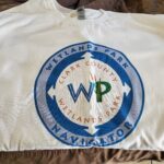 A white t - shirt with the word wp on it.