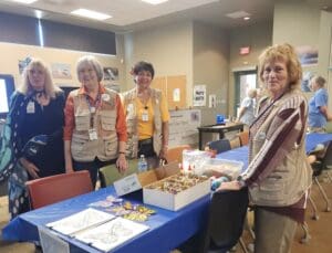 Four women in a community gathering room.