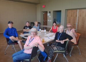 Group of people sitting around a table.